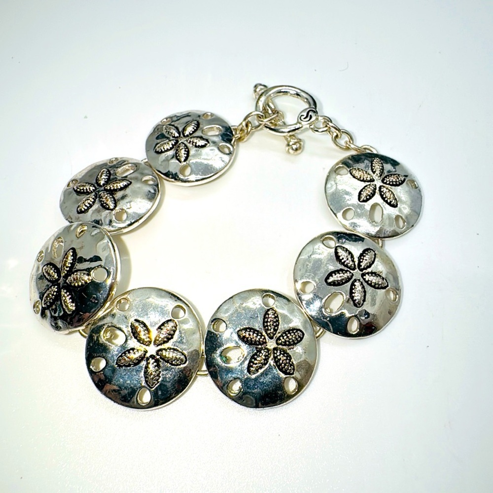 Plunder silver tone sand dollar bracelet.​​